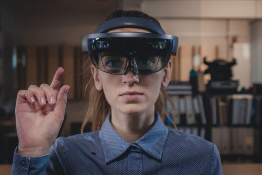 Image of a woman in VR/AR headset to show what it would look like for someone to wear HoloLens or alternatives.